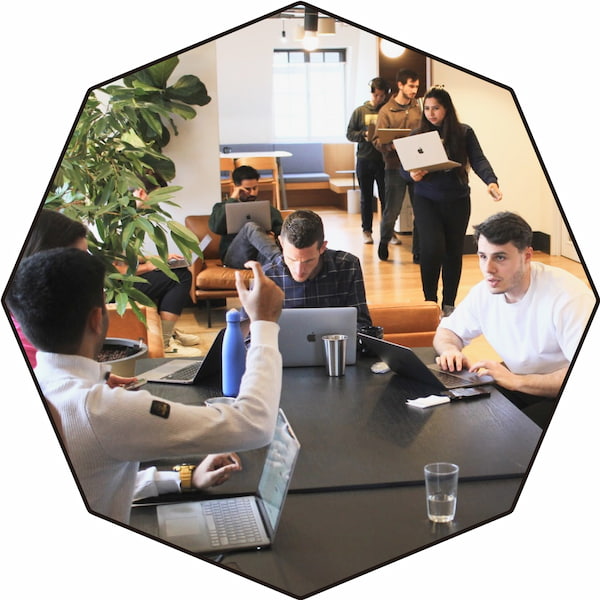 A group of people gathered around a table in discussion