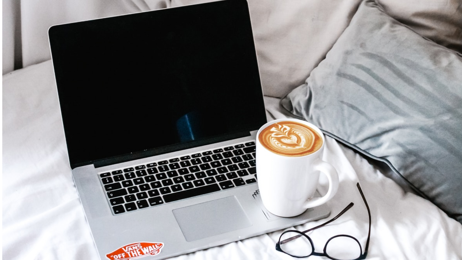A laptop with a coffee mug