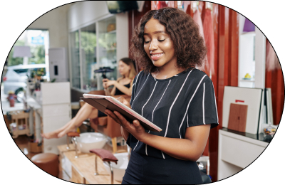 A salon manager standing in her salon while checking her appointments